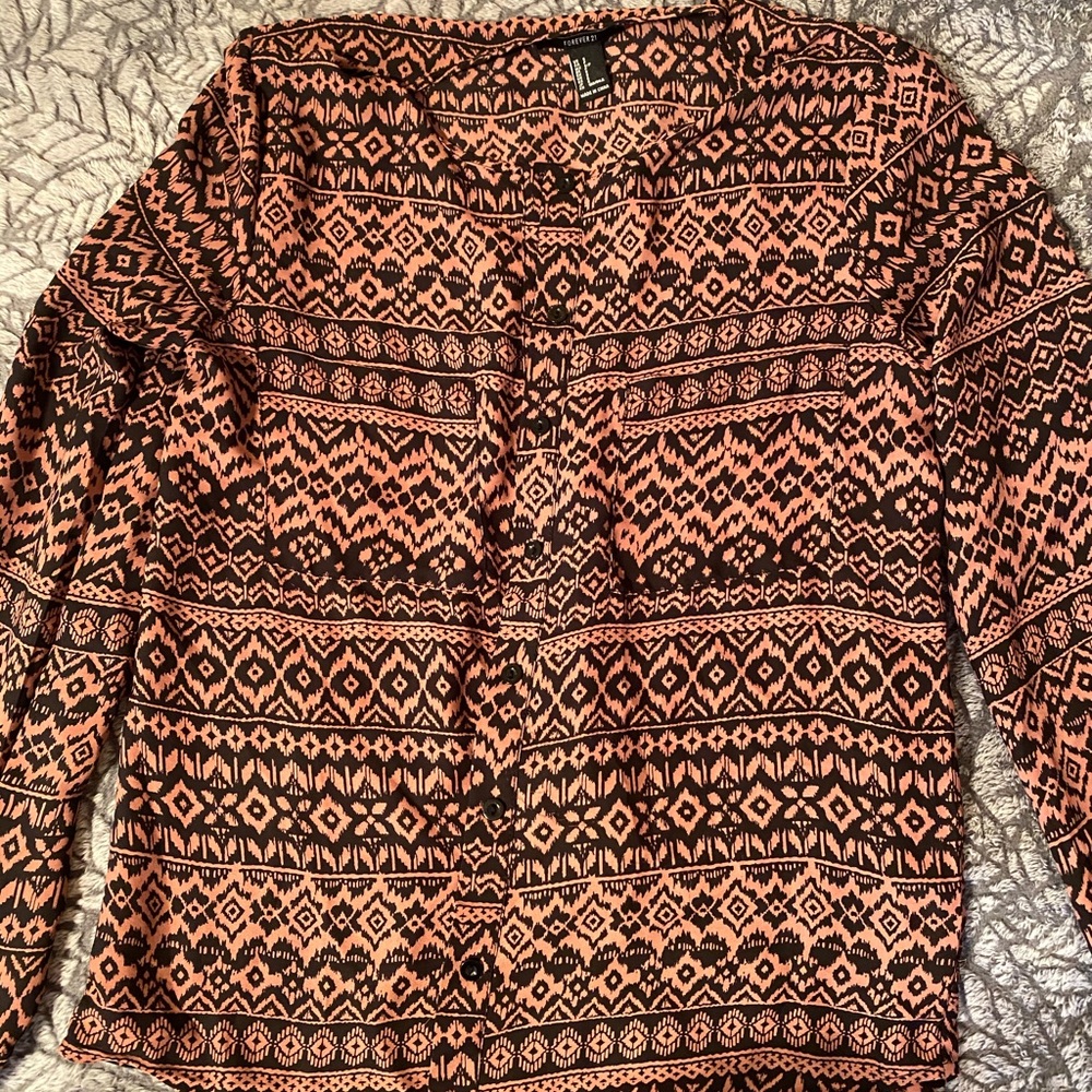 This is a long-sleeved silky button up top